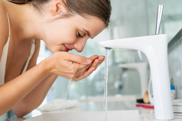 istock Woman washing her face 1280099002