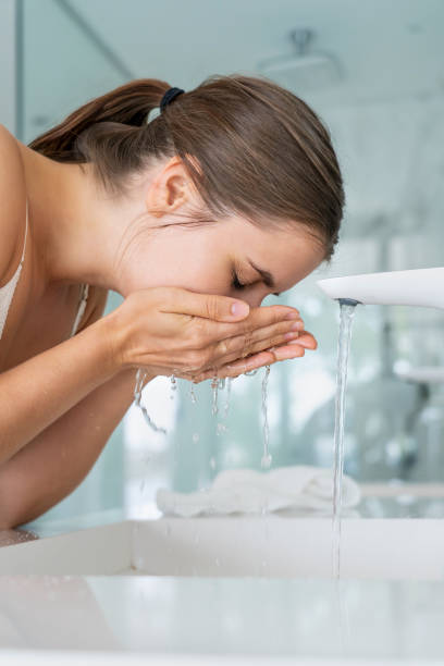 istock Woman washing her face 1280099009