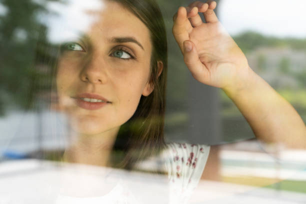 istock Woman looking through glass 1280099136