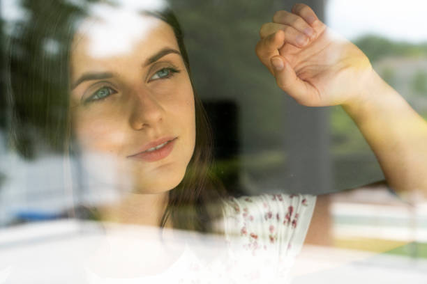 istock Woman looking through glass 1280099190