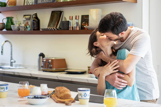 istock Couple kissing in kitchen 1280099339
