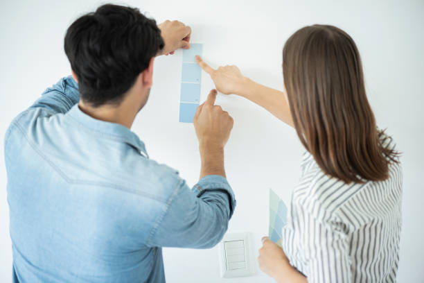 istock Young couple choosing colour for wall 1280099380