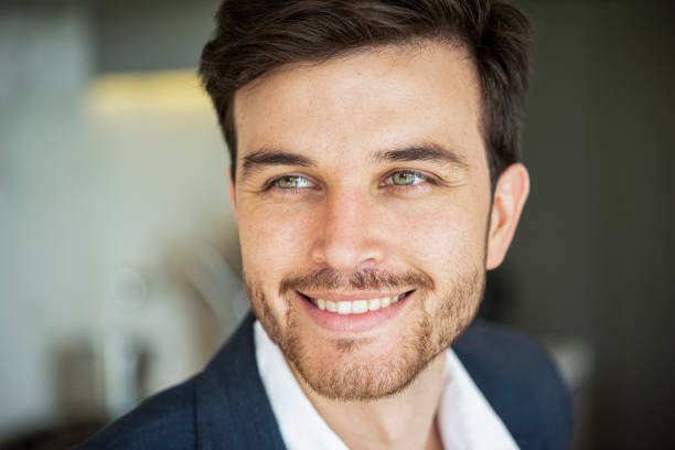 Close-up of smiling young man in blazer and beard