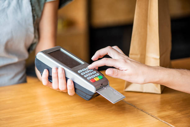 istock Customer entering PIN number on credit card reader 1280100059