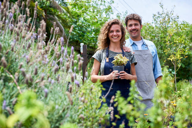 istock Couple standing in plant nursery 1280100077