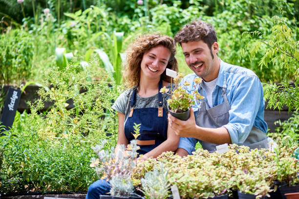istock Young couple sitting in plant nursery 1280100091
