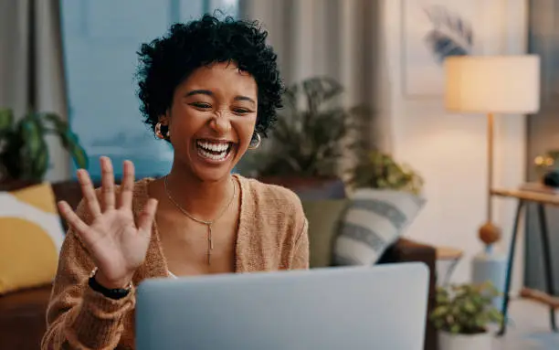 Shot of a young woman making a video call on a laptop at home