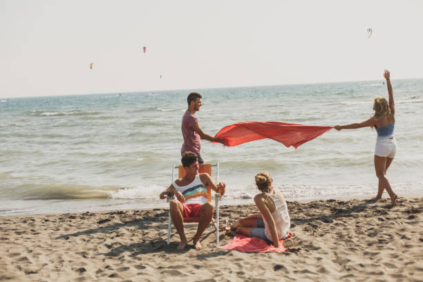 istock People enjoy summertime in different ways by the beach 1280101828