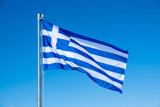 istock Greek flag waving against blue sky background. 1280104162