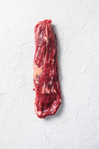 istock Raw skirt, machete steak on a white stone background vertical 1280104666