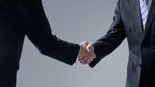 Photo of Businessperson shaking hands. Business connection concept.