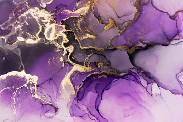 Photo of Closeup of purple and shiny golden alcohol ink abstract texture, trendy wallpaper.