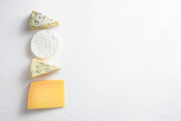 istock Cheese platter: yellow Maasdam, white Camembert and blue cheese Dor Blue  on white background. Copy space.  Concept serving cheese. Top view text space for you 1280107491