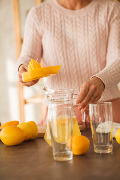 istock Unrecognizable mature woman making fresh lemonade 1280108604