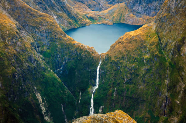 Amazing aerial view of Fiordland National Park on scenic flight from Milford Sound to Queenstown, New Zealand Lake Quill and Sutherland Falls in the mountain milford sound stock pictures, royalty-free photos & images