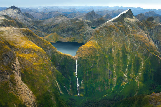 Amazing aerial view of Fiordland National Park on scenic flight from Milford Sound to Queenstown, New Zealand Lake Quill and Sutherland Falls in the mountain new zealand stock pictures, royalty-free photos & images