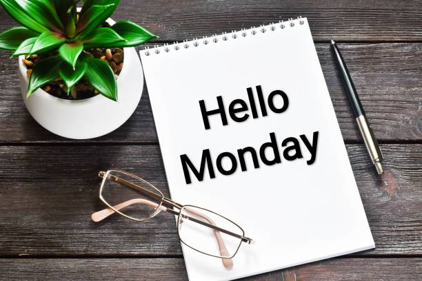istock Hello monday - text on notepad with pen and flower on wooden table. 1280112000