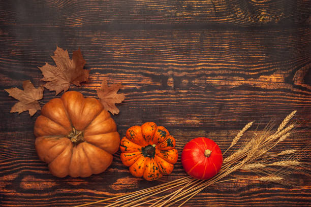 istock Wooden background with pumpkins and maple leaves, flatlay with copy space 1280112535