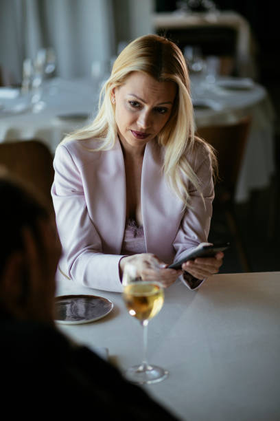 istock Businesswoman using the phone in the restaurant. 1280112648