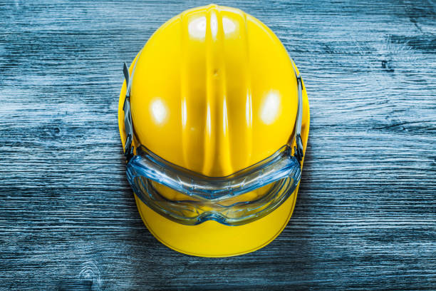 istock Safety hard hat goggles on vintage wooden board 1280115046