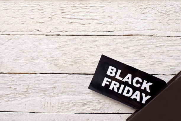 istock label Black Friday on white wood background with space for text. 1280116133