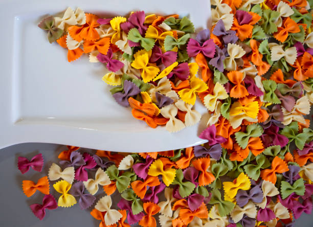 istock Multi-colored pasta in the shape of butterflies loose 1280116867