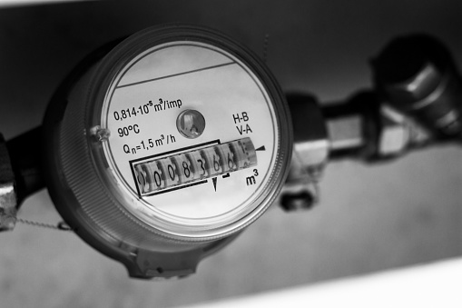 water meter and plumbing close-up black and white photography