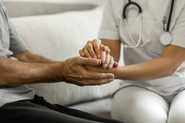 istock Senior man holding hands with a nurse 1280119338