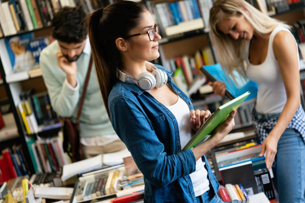 istock Education concept. University students preparing for exam, talking in library 1280119570