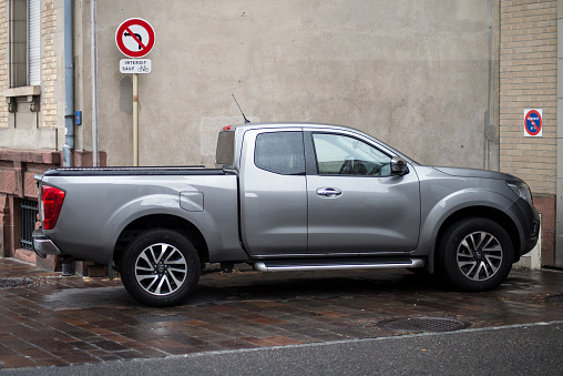 Mulhouse - France - 22 August 2020 -  Profile view of grey Nissan Navara pickup parked in the street