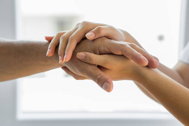 istock Doctor hand on elderly senior patient 1280120741