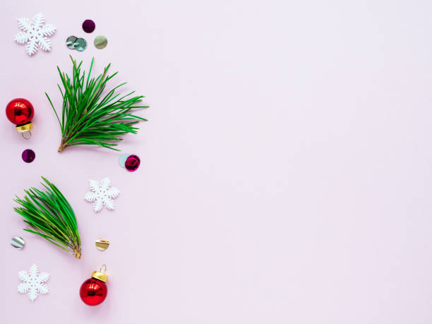 istock Green Christmas tree branches and decorations on a pink background, top view, copy space, flat lay 1280121289