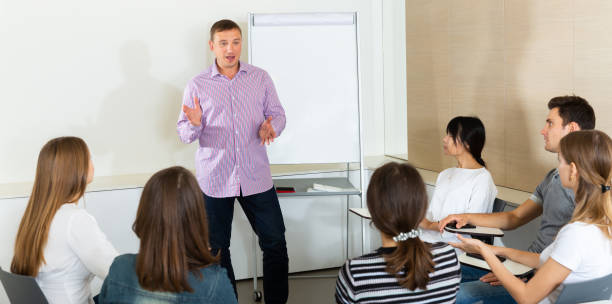 istock Man reading out report to colleagues 1280124035