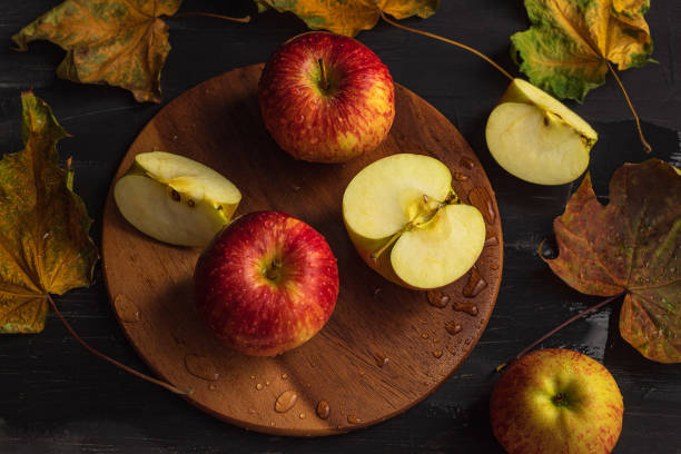 istock A small amount of ripe apples along with maple leaves on a black background 1280129458