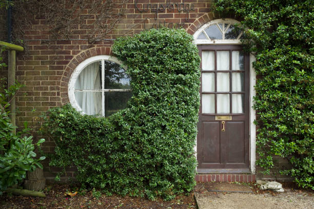 Buckingham, UK - August 05, 2020. Facade of a small UK cottage with round window and front door