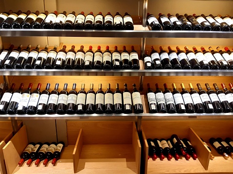Interior of a Wine shop with wooden shelves and soft lighting, Nice marriage between two noble products: wood and wine.