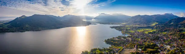 Tegernsee Lake. Beauty in Nature. Aerial Panorama Shot in Autumn. Sunset at Travel Location
Bavaria, Germany, EuropeTegernsee Lake. Aerial Drone Panorama in Fall. Bavarian Alps. Germany Europe. Green Fields Mountains and Beautiful Lake.