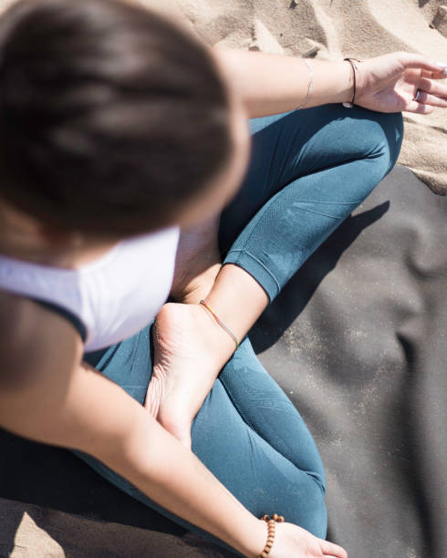 istock Attractive woman doing Yoga poses on the beach 1280131476