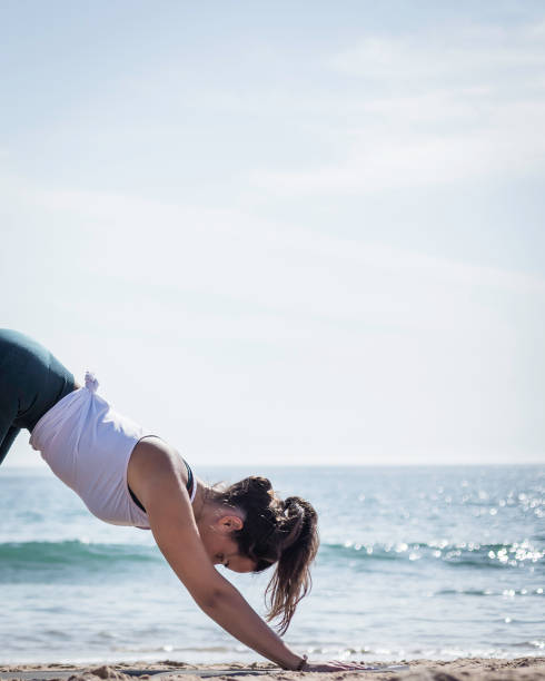 istock Attractive woman doing Yoga poses on the beach 1280131501