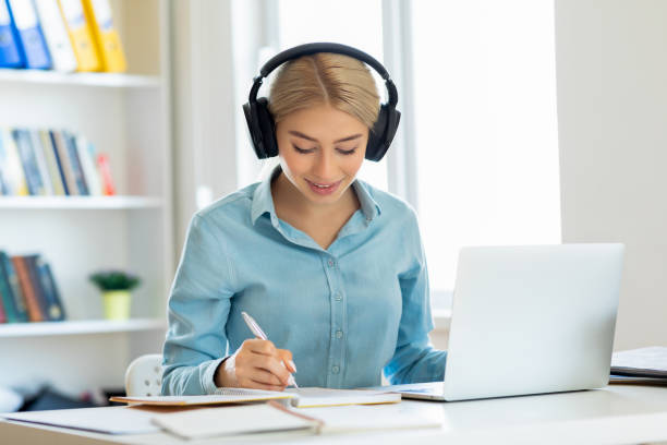 istock Smiling girl with headset studying online 1280131605