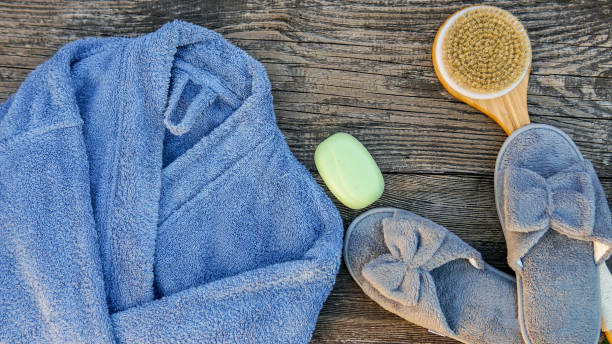 istock Spa day concept. Spa and wellness setting with bathrobe, brush, soap with lavender scent, slippers 1280132832