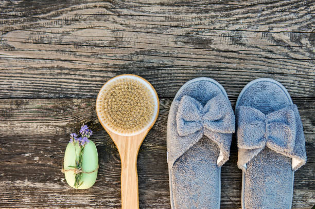 istock Spa day concept. Spa and wellness setting with bathrobe, brush, soap with lavender scent, slippers 1280132833
