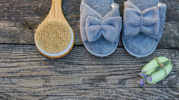 istock Spa day concept. Spa and wellness setting with bathrobe, brush, soap with lavender scent, slippers 1280132849
