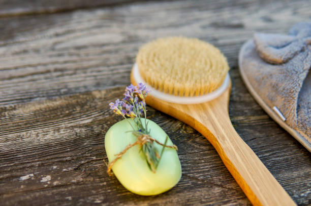 istock Spa day concept. Spa and wellness setting with bathrobe, brush, soap with lavender scent, slippers 1280132895
