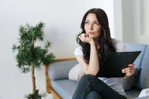 istock Positive brunette woman fill in information in questionnaire making application for hire on vacancy 1280132926