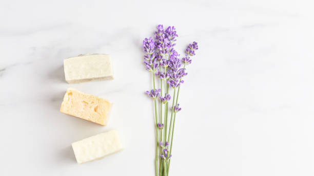 istock cosmetics concept panoramic banner. stack of handmade soap, mini lavender bouquet on marble background. flat lay, copy space 1280133444