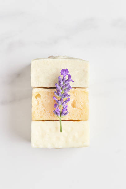 istock a stack of hand-made soap, decorated with a fresh lavender branch on a marble background. flat lay, top view 1280133446