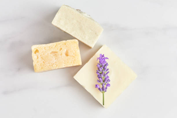 istock stack of hand-made soap, decorated with a fresh lavender branch on a marble background. flat lay, top view 1280133456