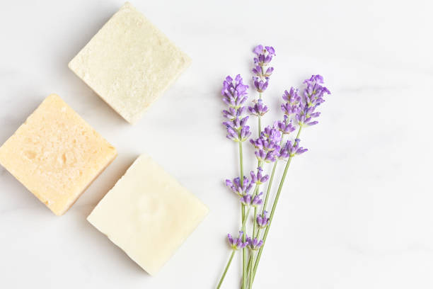 istock natural cosmetics concept. stack of handmade soap, mini lavender bouquet on marble background. top view, copy space 1280133469