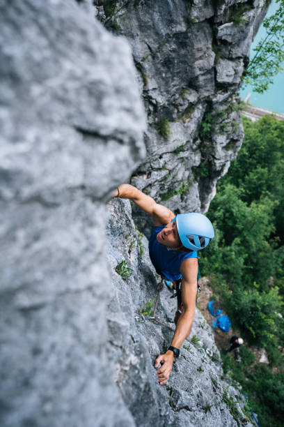 istock View of man climbing up mountain ridge above lake 1280134629
